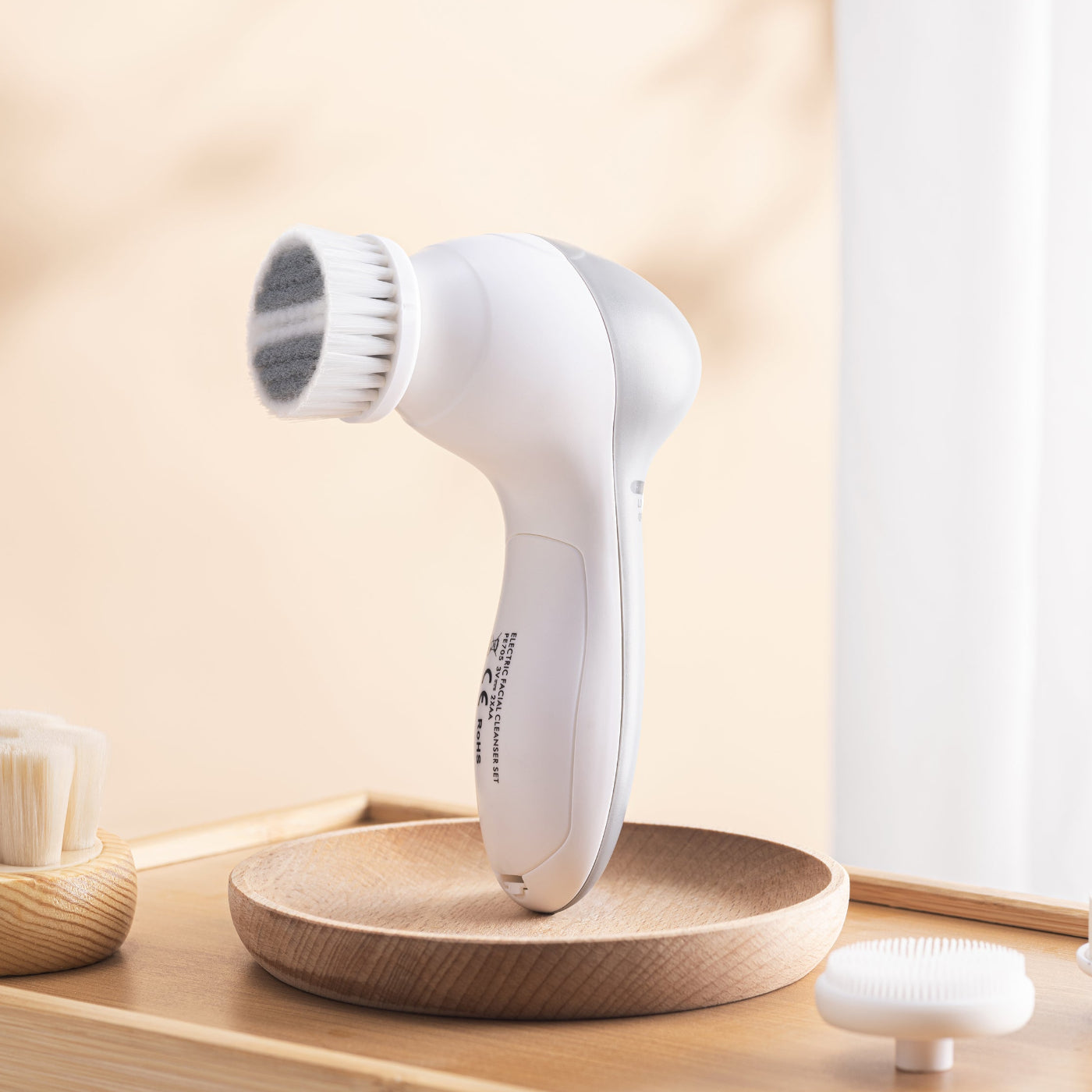 Project E Beauty Bora facial cleanser set shown with soft bristle and silicone brush head attachments.